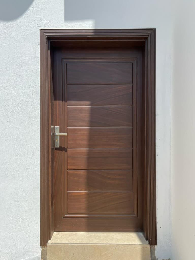 Dark wood entrance door with horizontal recessed panels