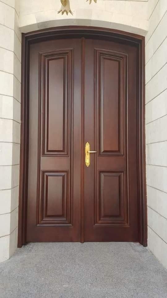 Arched double entrance doors in dark polished wood