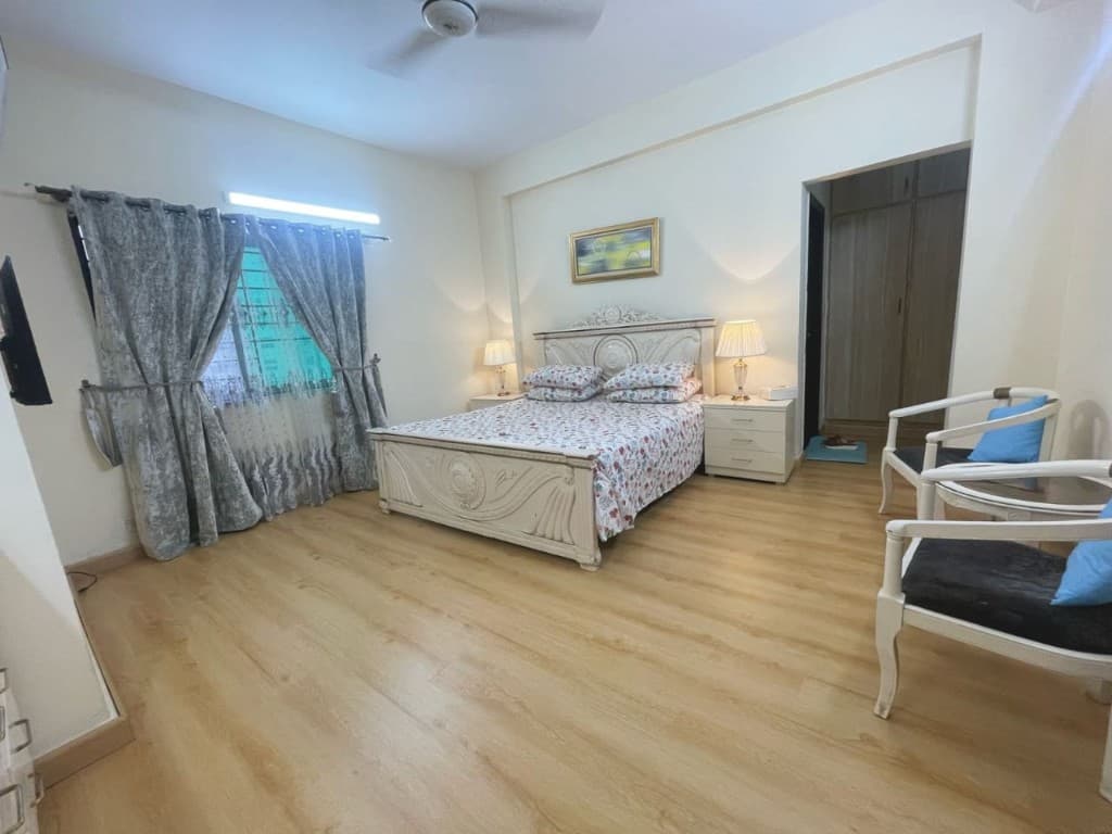Bedroom with light oak wooden laminate flooring