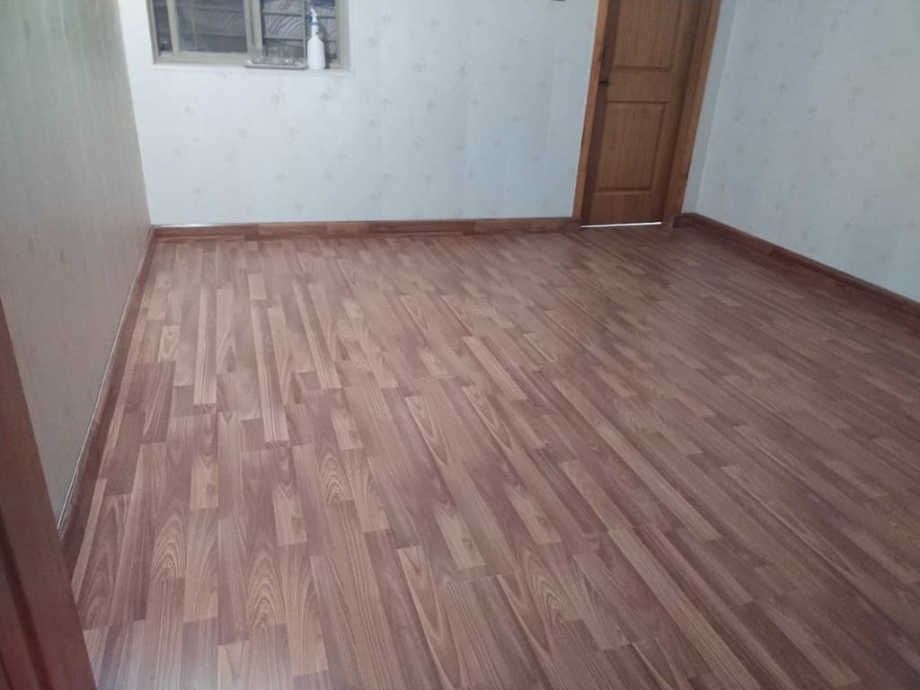 Empty room with warm medium-brown wood plank flooring
