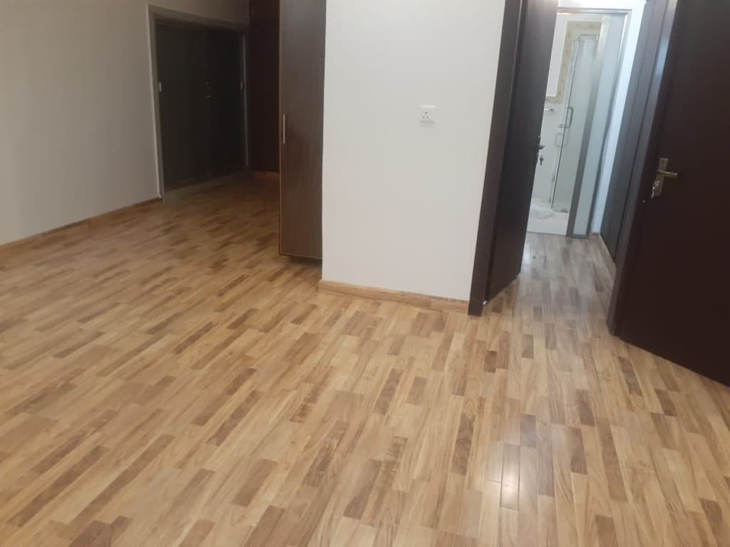 Hallway with multi-tone honey wood laminate flooring