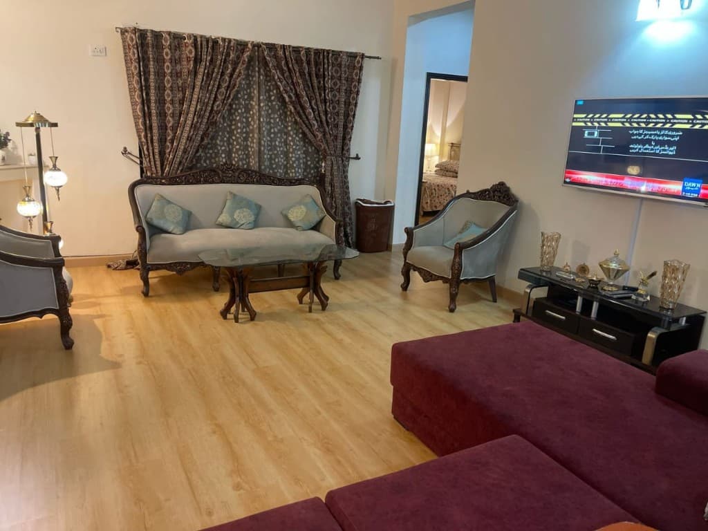 Living room seating area with light wooden laminate floor
