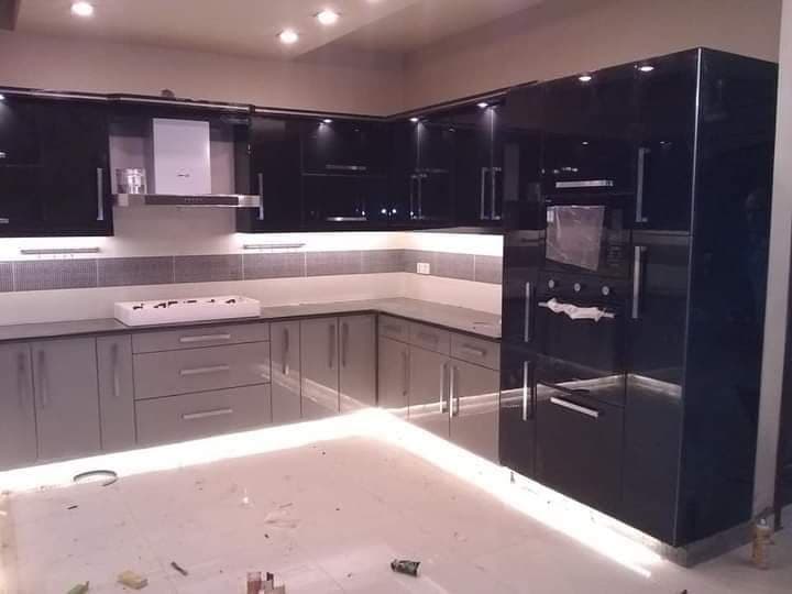 Black and grey high-gloss kitchen with under-cabinet LED lighting