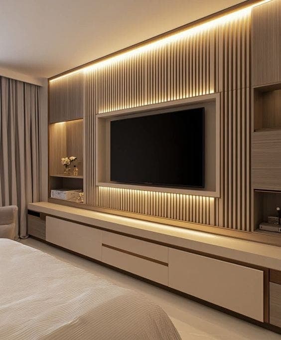 Bedroom media wall with wood slats, LED lighting, and floating console