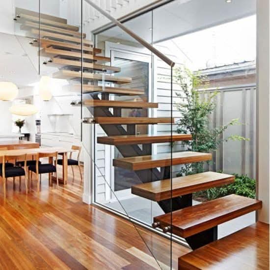 Floating wood staircase with glass balustrade and wooden handrail