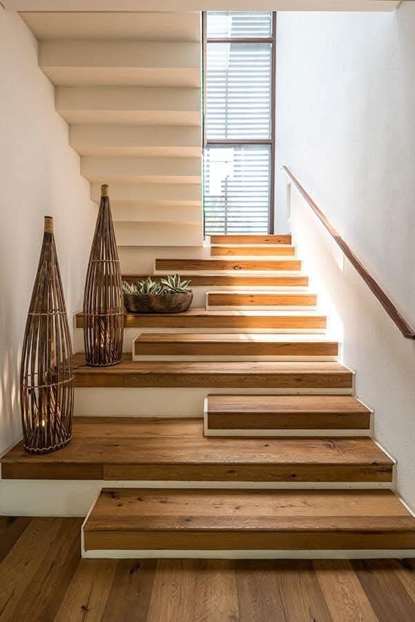 Minimalist wood-and-white staircase with wide platform steps