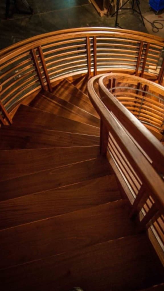 Dark wood spiral staircase with horizontal slat balustrade