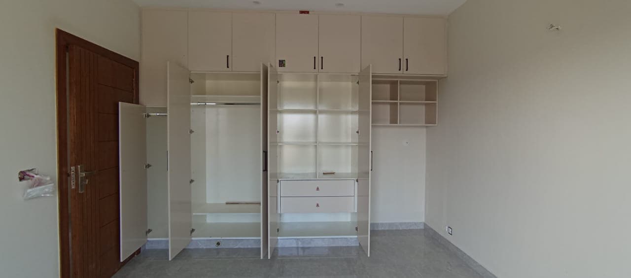 Custom built-in wooden wardrobe with clean panels