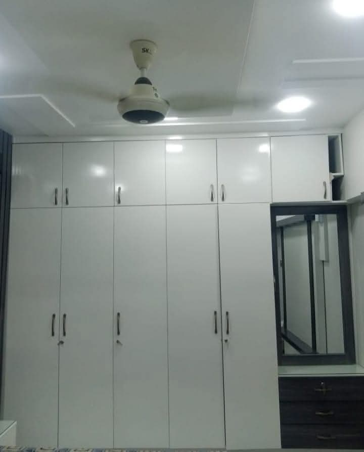 Custom wardrobe installation in residential bedroom